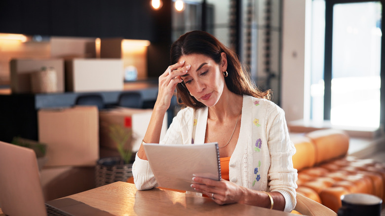 Frustrated looking woman looking at a contract