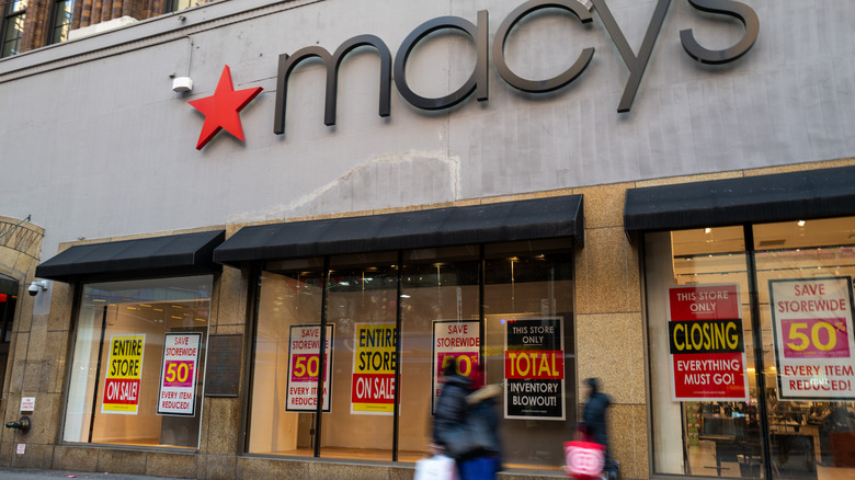 macy's store with a series of store closing signs in the windows