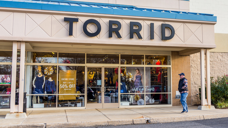 Man standing in front of Torrid store
