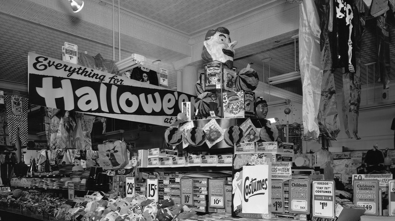 Vintage black and white photograph of a store selling Halloween products.