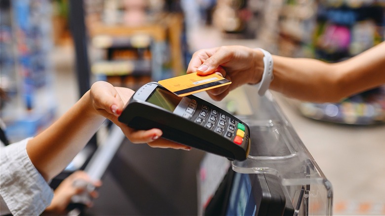 Person tapping credit card terminal
