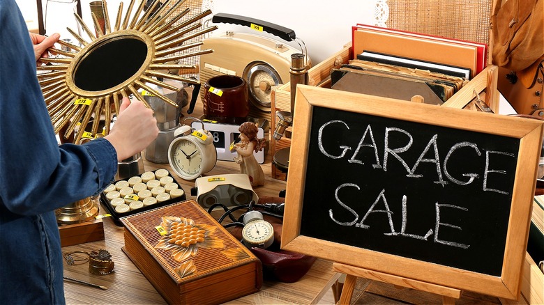 Person inspecting garage sale items