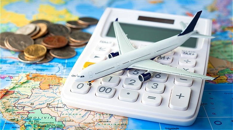 Model airplane, calculator on map
