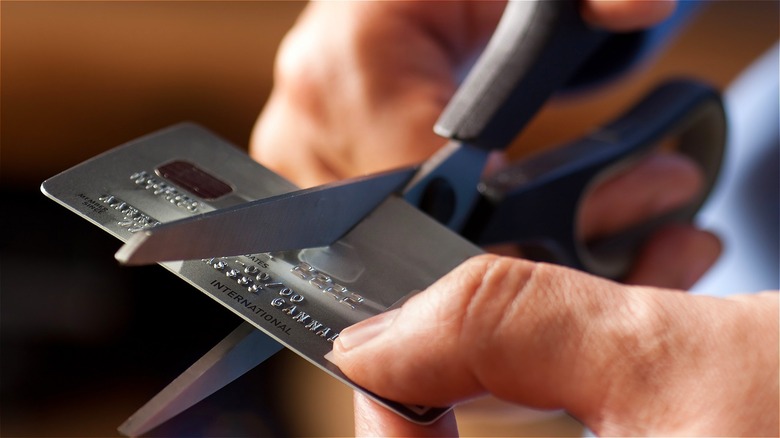 Person cutting up credit card