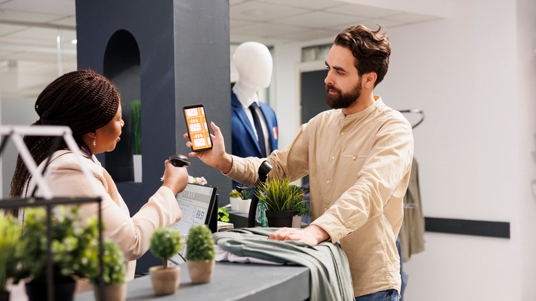 a man makes a payment with a smartphone