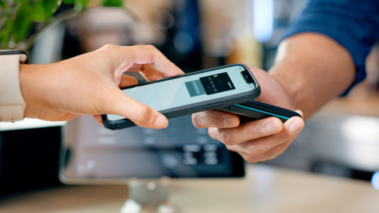 two people exchange a payment via smartphone app