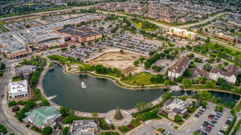 An overhead view of West Des Moines, Iowa, featuring a small lake, shops, and neighborhoods