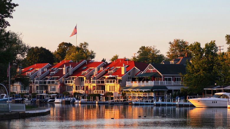Building alongside body of water, with boats docked.