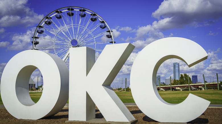 OKC sign in front of ferris wheel