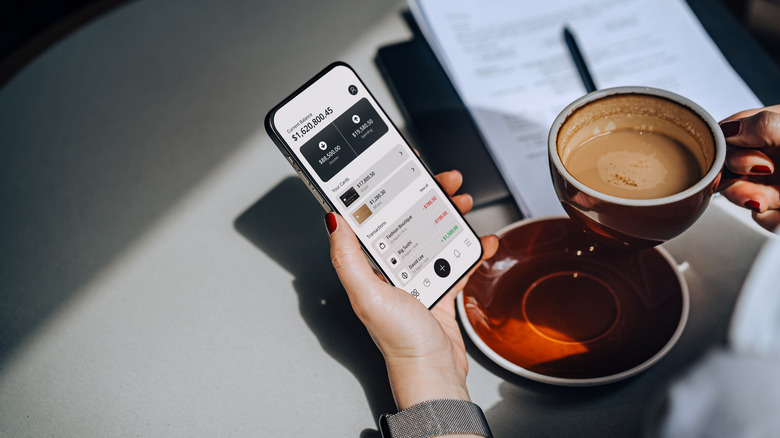 Person looking at checking account on phone.