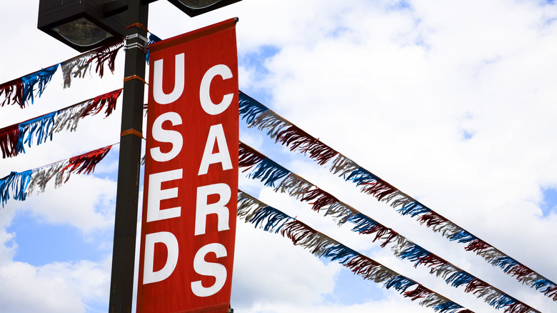 A used car sign above a dealership