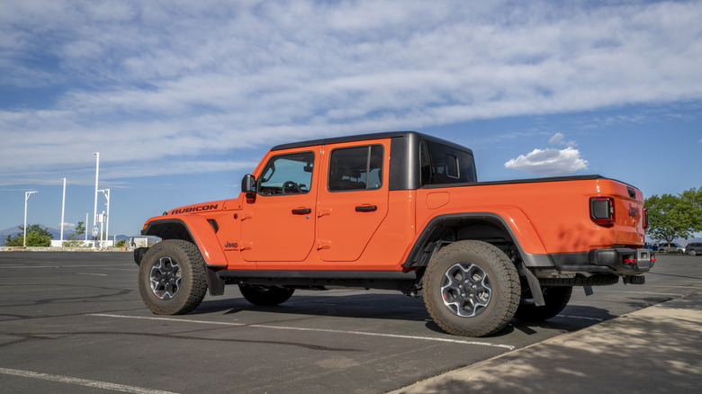 Jeep Gladiator in parking lot with clouds in background