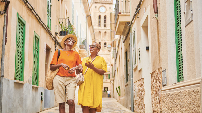 Two female tourists walking down street in Europe