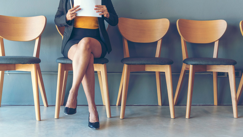 woman sitting in chair waiting for interview