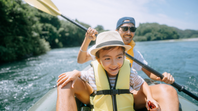 Father and child having a good time on a packraft