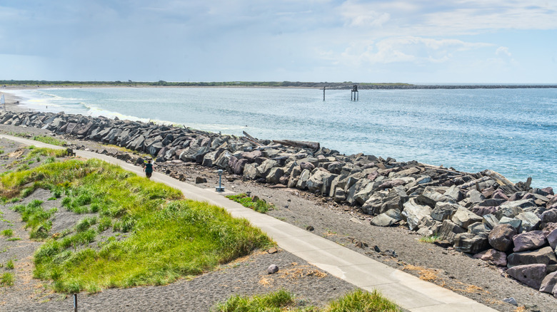 A rocky breakwater lines the shore in Westport, Washington.