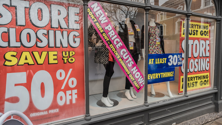 Shop window with sale and store closing display