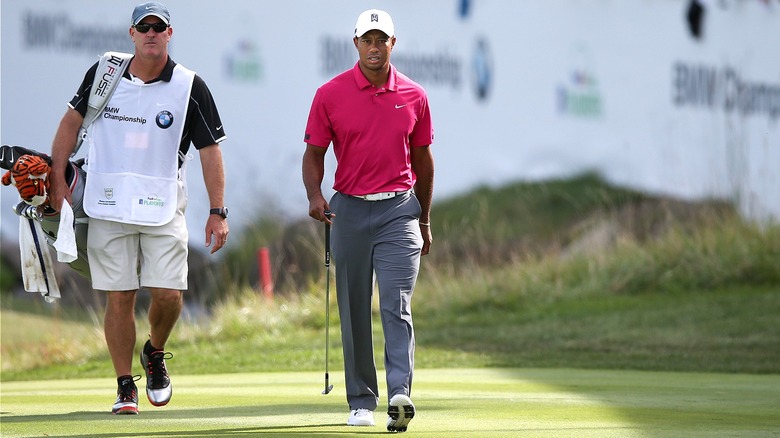 Tiger Woods, caddie at tournament