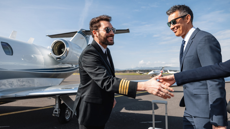 Private jet pilot meets passengers.
