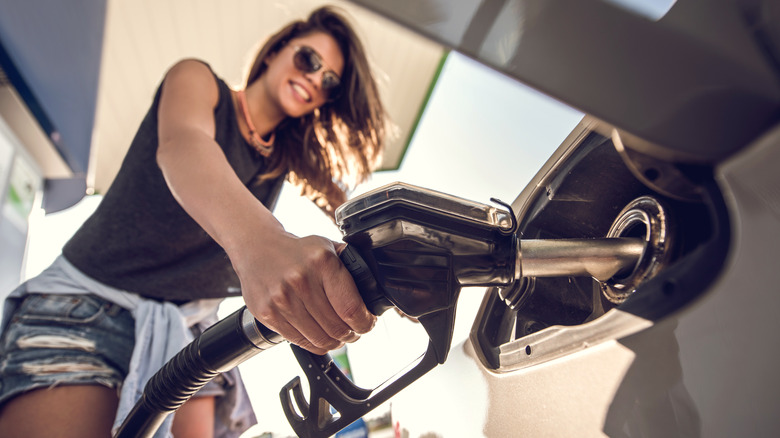 woman filling car gas tank
