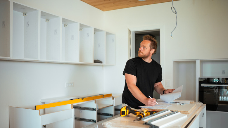 Young man remodeling his kitchen DIY style