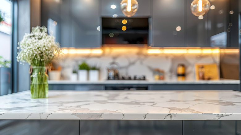Veined kitchen marble top counter with vase of flowers