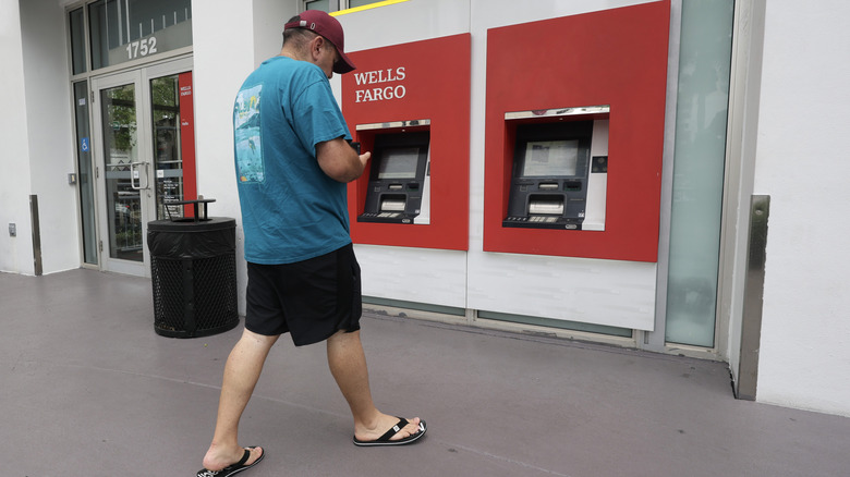 A man walks toward a Wells Fargo ATM