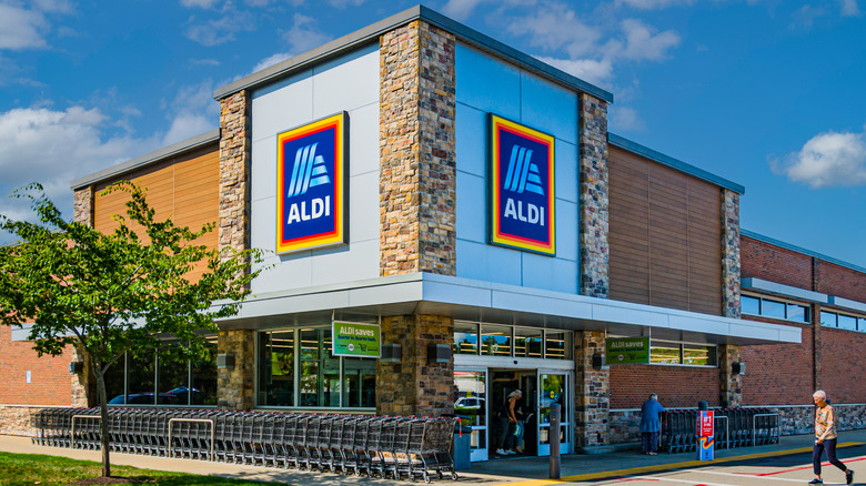 An Aldi corner storefront on a bright, blue day