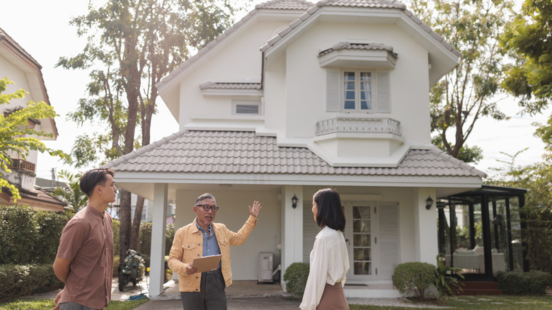 An agent showing a couple a home.