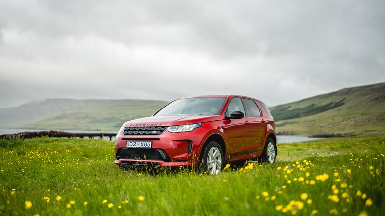 A red Land Rover Discovery Sport in Iceland.