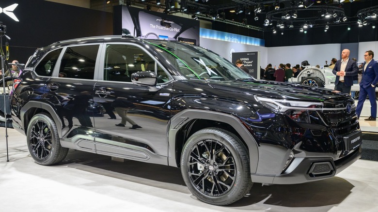 Black 2026 Subaru Forester displayed under bright lights at an indoor auto show