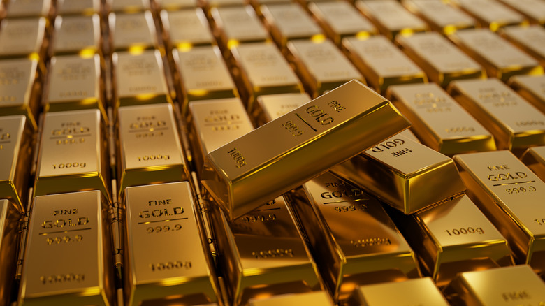 Two gold bars criss-crossed on top of other gold bars