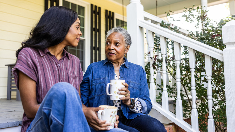 Two woman sitting on front porch