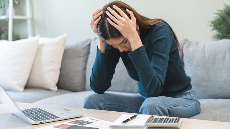 Women stressed as she budgets.