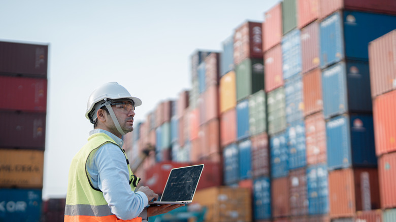 Person working at a shipping container yard