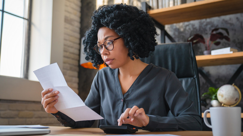 A young woman paying her energy bill