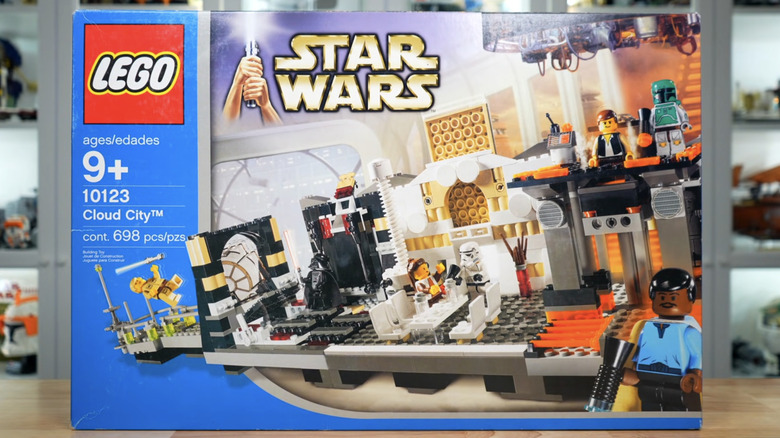 An exterior shot of the 10123 Lego Star Wars Cloud City set on a wooden table with other lego structures in the background