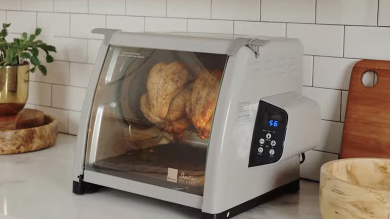 A group of tabletop ovens all sitting on a kitchen counter