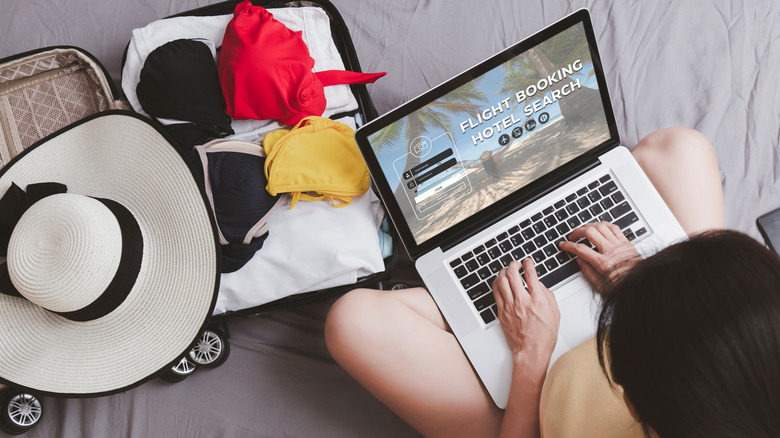 traveler booking a flight on laptop
