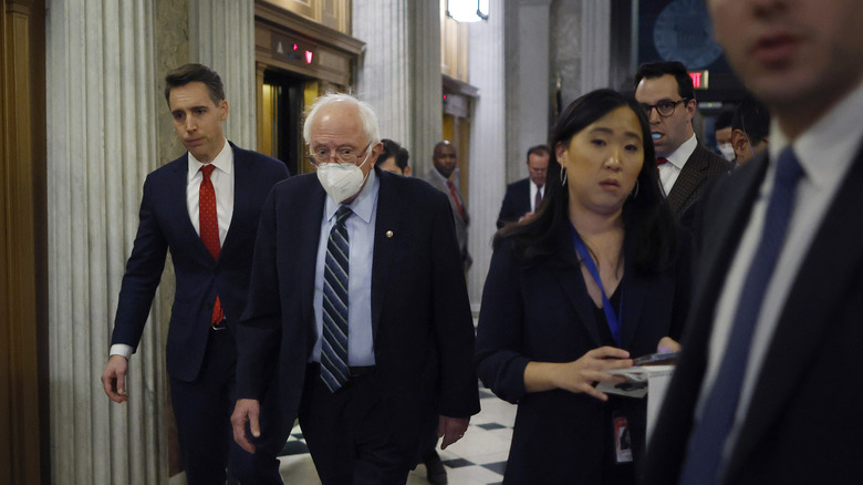 Senators Josh Hawley and Bernie Sanders walk down the halls of Congress in 2022.