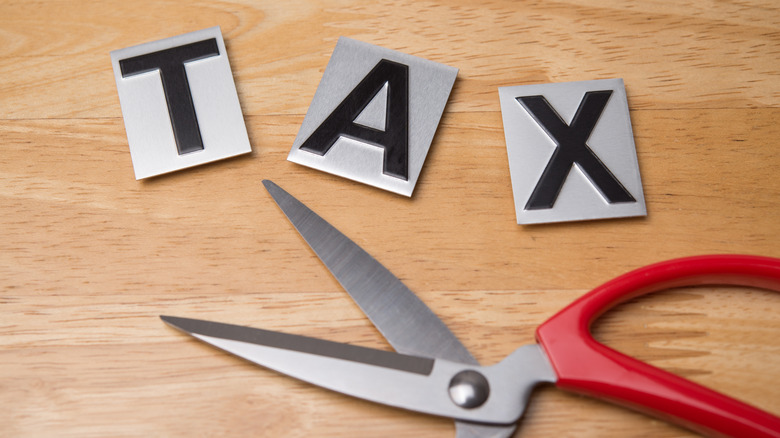 Tax in letters and a pair of scissors