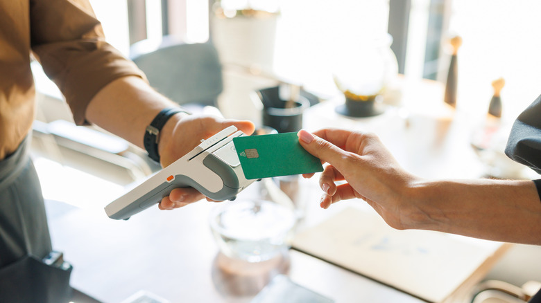 Person making a purchase with a credit card.