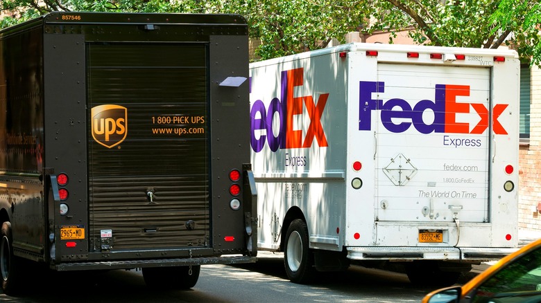 UPS and FedEx trucks side-by-side