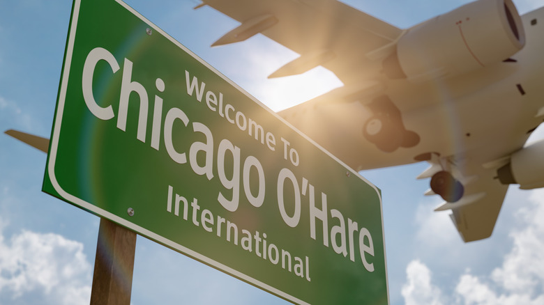 Welcome to Chicago O'Hare International Airport Green Road Sign with Airplane Above.