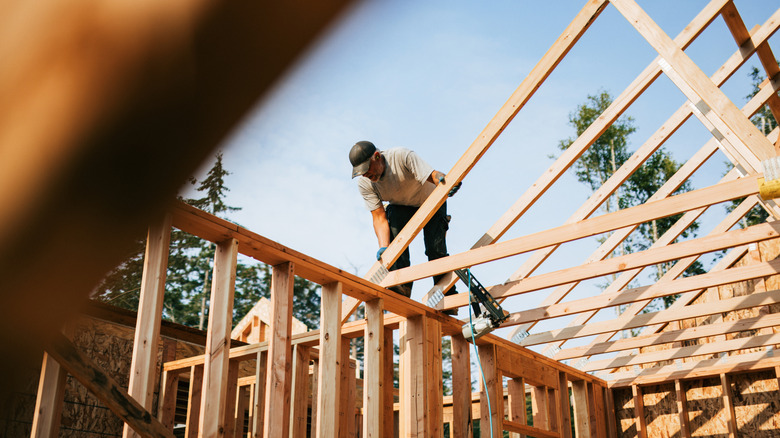 a man works on building a home