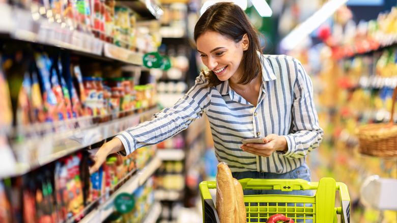 Smiling woman grocery shopping