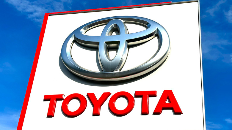 The sign for a Toyota dealership against a clear blue sky