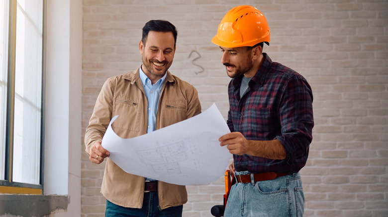 Middle-aged homeowner discussing renovations with a contractor