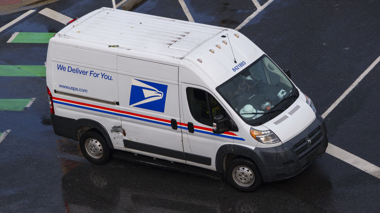 A United States Postal Service van drives down a Washington, D.C. street in the summer of 2025.