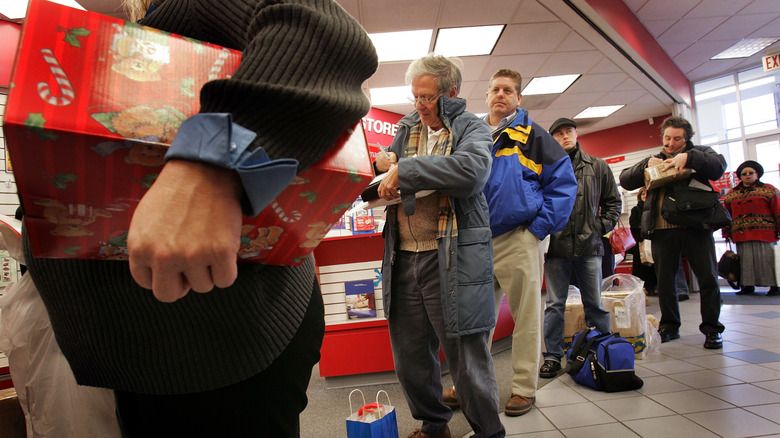 People wait in line to send packages in a U.S. Post office in Washington, D.C. in December 2024.